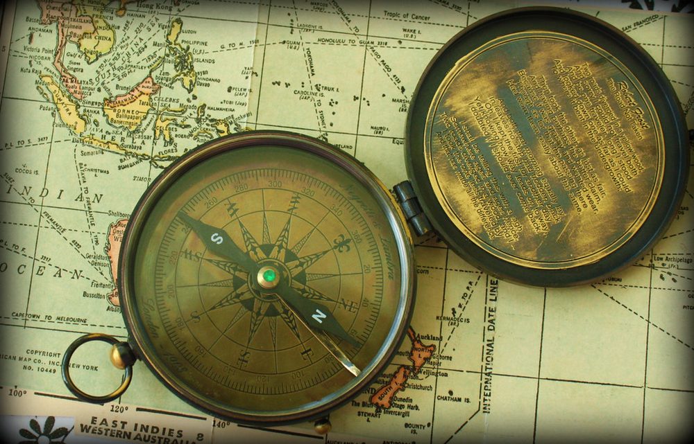 A compass resting on a map